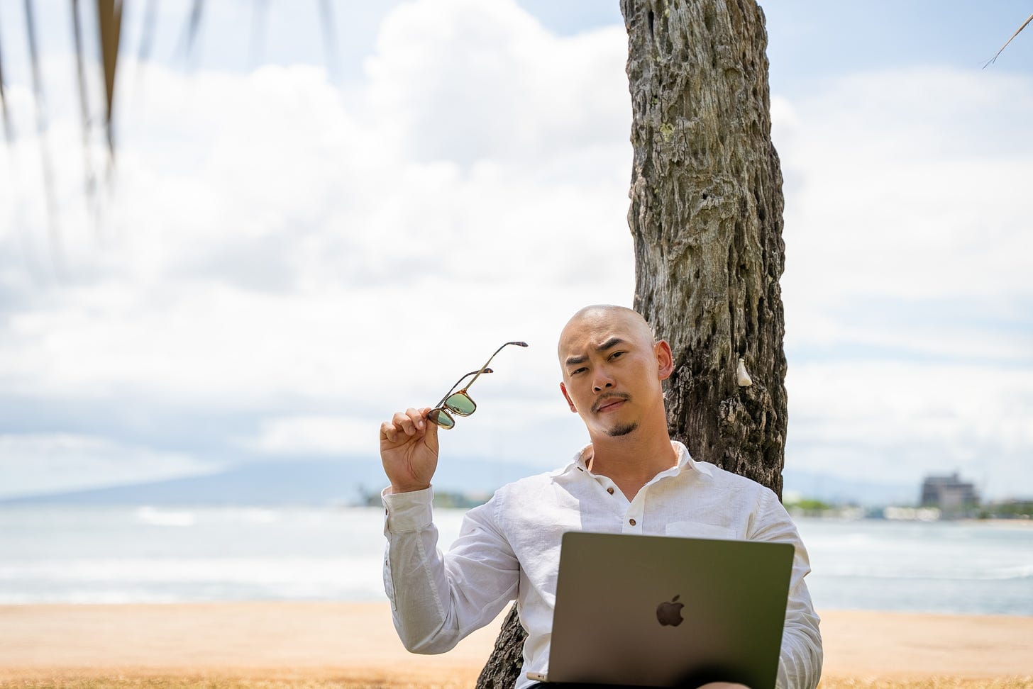 Man Using Laptop at Exotic Beach