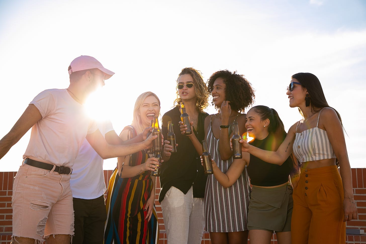 Cheerful diverse friends having party on terrace